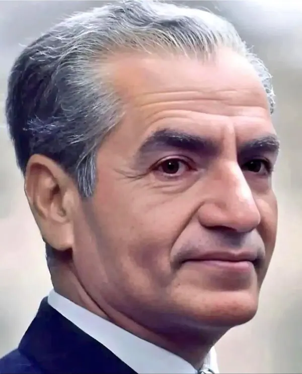 A close-up portrait of an older man with grey hair wearing a dark suit and white collar — a public domain photograph from The Shah of Iran archive documenting the Pahlavi era.