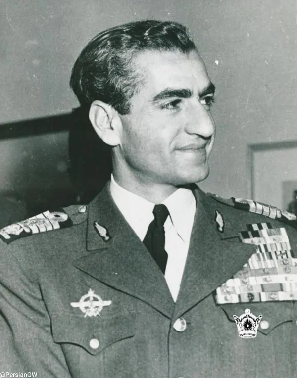 His Majesty, the Shah of Iran in a decorated military uniform looks to the side in a waist-up portrait — a public domain photograph from The Shah of Iran archive documenting the Pahlavi era.