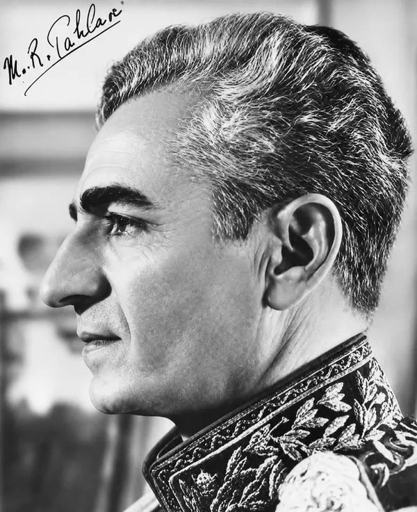 His Majesty, the Shah of Iran in a decorated military uniform is shown in a side profile portrait — a public domain photograph from The Shah of Iran archive documenting the Pahlavi era.