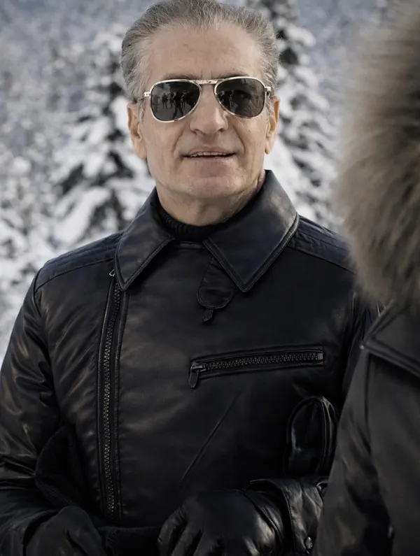 His Majesty, the Shah of Iran wearing sunglasses and a black leather jacket stands against a snowy forest background — a public domain photograph from The Shah of Iran archive documenting the Pahlavi era.