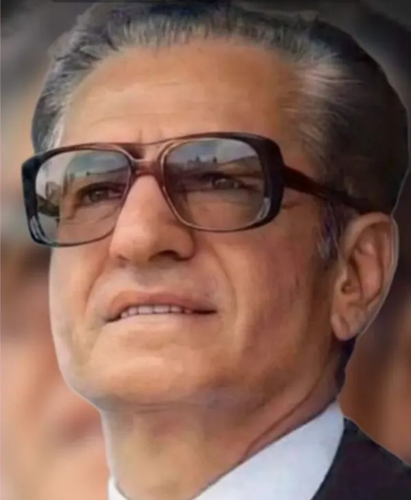 His Majesty, the Shah of Iran with dark hair wears large brown-rimmed glasses and a white collared shirt — a public domain photograph from The Shah of Iran archive documenting the Pahlavi era.