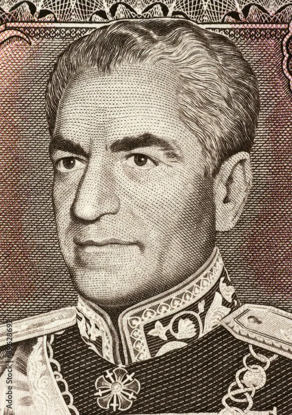 An older man in a decorated military uniform with a high collar and medals looks toward the side — a public domain photograph from The Shah of Iran archive documenting the Pahlavi era.