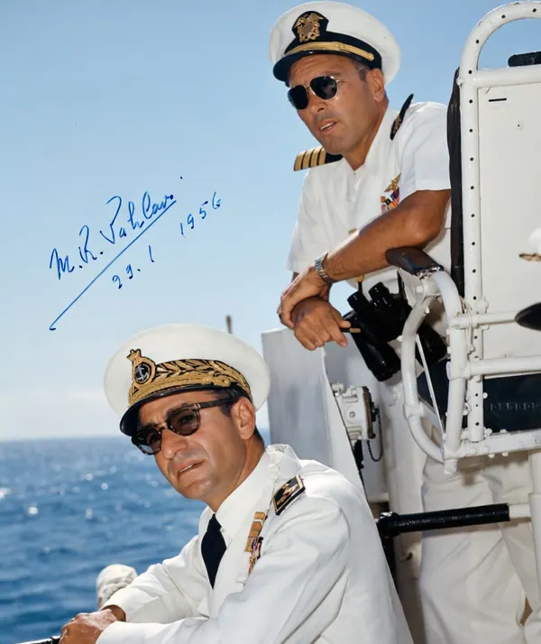 His Majesty, the Shah of Iran, and others in white naval uniforms and peaked caps stand on a ship deck against a blue sea — a public domain photograph from The Shah of Iran archive documenting the Pahlavi era.
